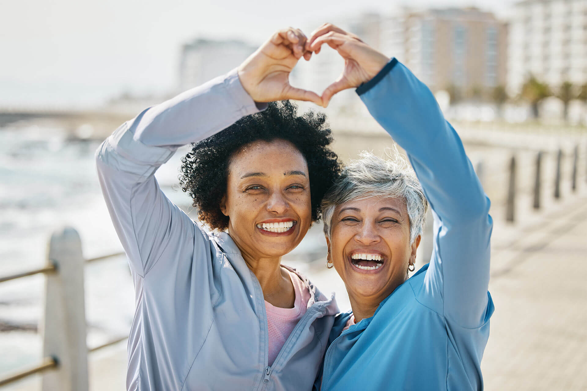 friends at the beach, embracing heart, hands, and fitness for health